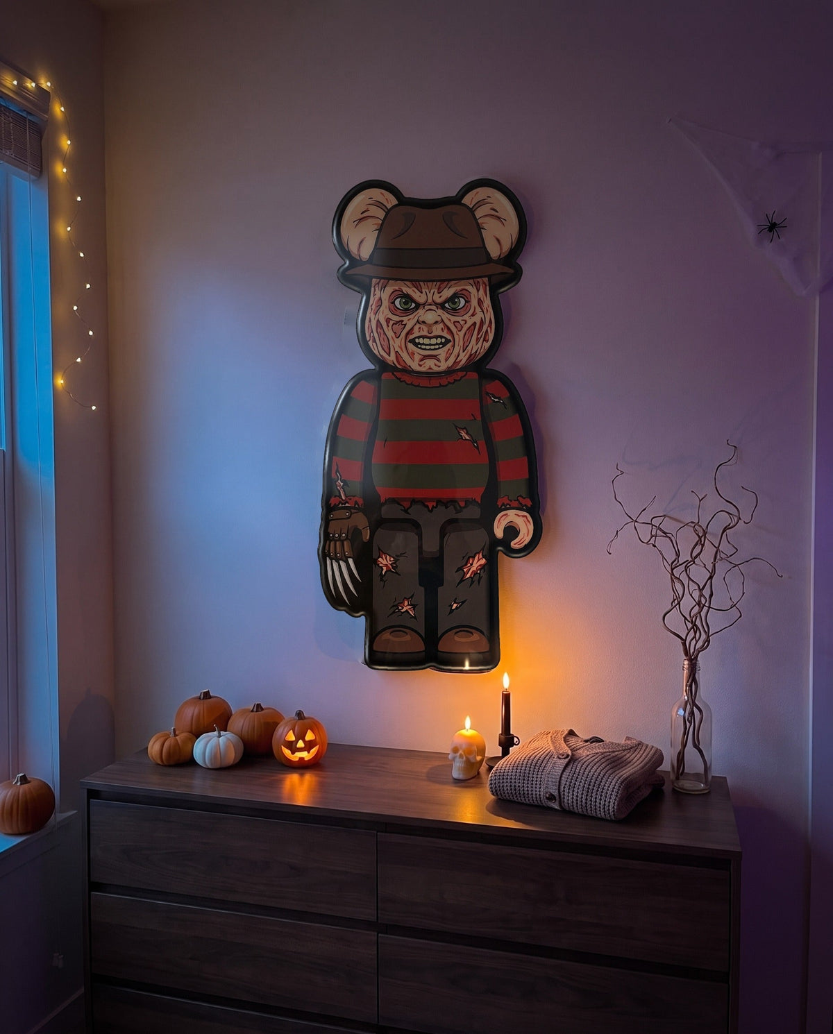 Freddy Halloween Bear Wall Art hanging on the wall above a dresser in a Halloween-decorated room