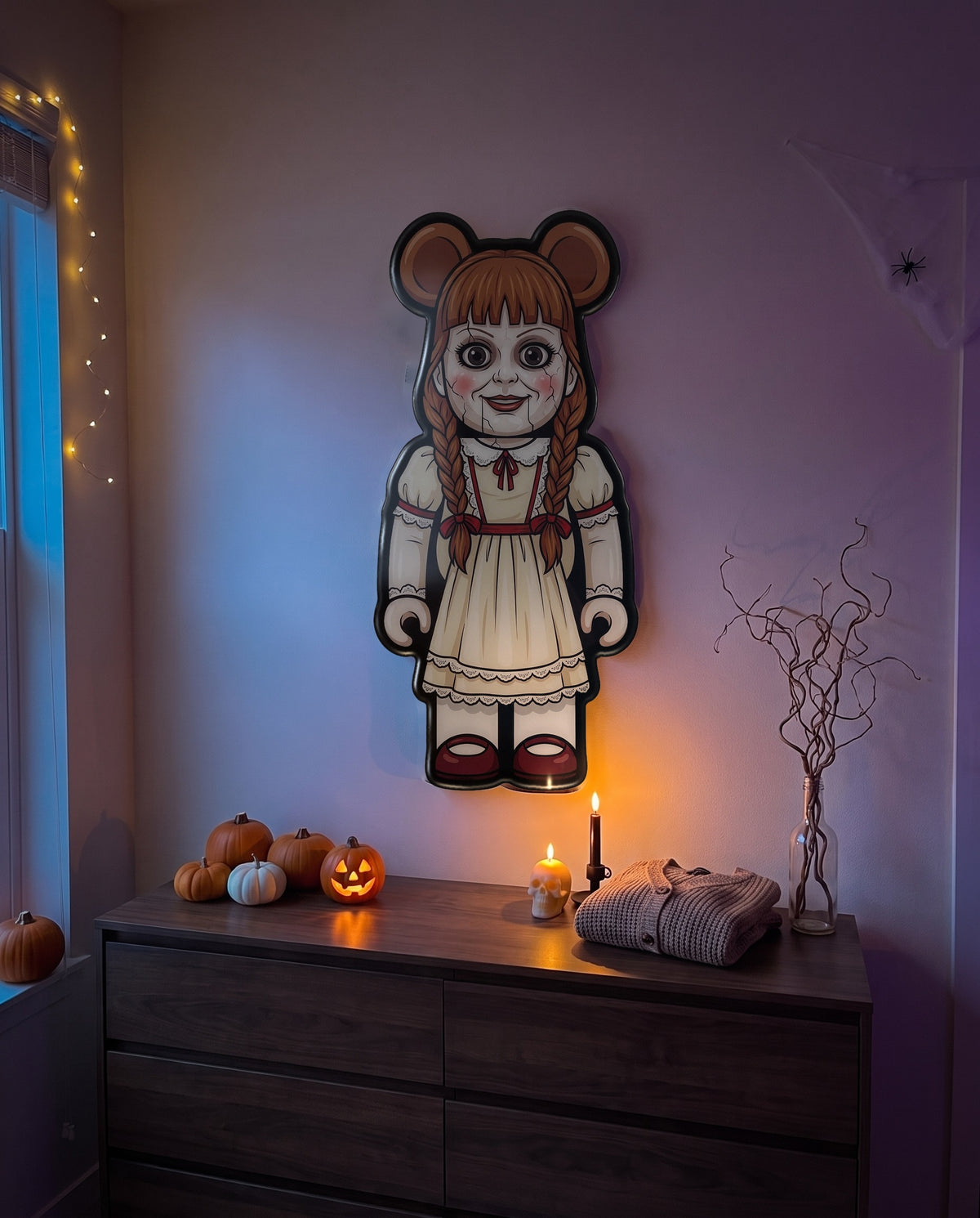 Annabelle Halloween Bear Wall Art hanging on the wall above a dresser in a Halloween-decorated room